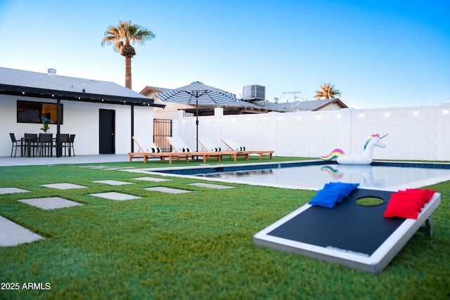 view of swimming pool with cooling unit and a patio area