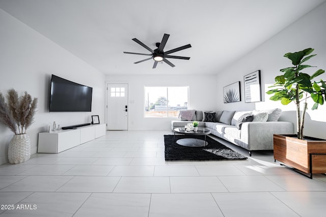 living area featuring ceiling fan and tile patterned floors