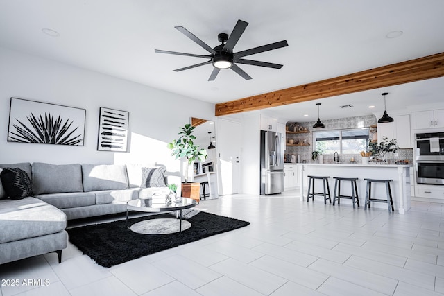 living room with a ceiling fan, beam ceiling, and recessed lighting
