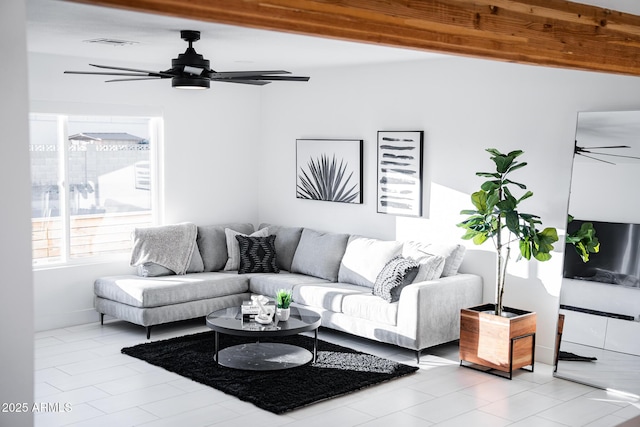 living area with ceiling fan, light tile patterned floors, and baseboards