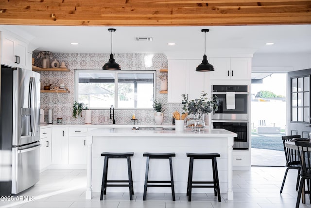 kitchen with appliances with stainless steel finishes, open shelves, a sink, decorative backsplash, and recessed lighting