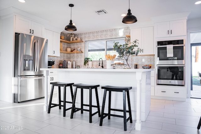 kitchen featuring stainless steel appliances, decorative backsplash, pendant lighting, and recessed lighting