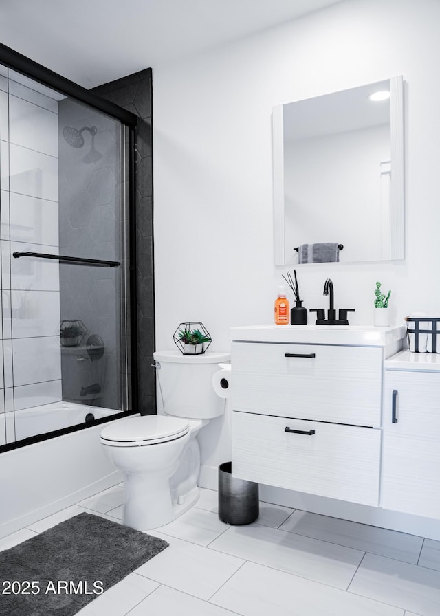 full bath featuring toilet, vanity, and bath / shower combo with glass door