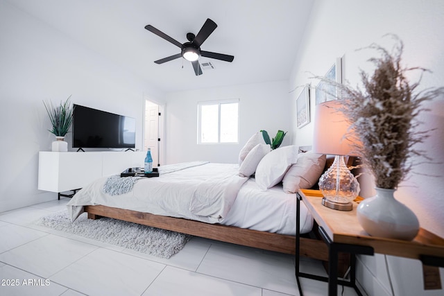 tiled bedroom featuring a ceiling fan