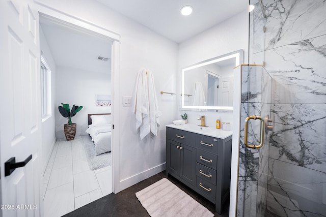 ensuite bathroom featuring a marble finish shower, vanity, recessed lighting, and tile patterned flooring