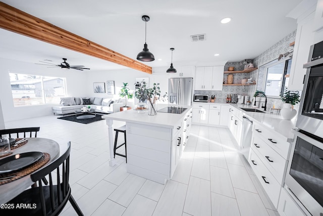 kitchen featuring stainless steel appliances, open shelves, recessed lighting, decorative backsplash, and light countertops