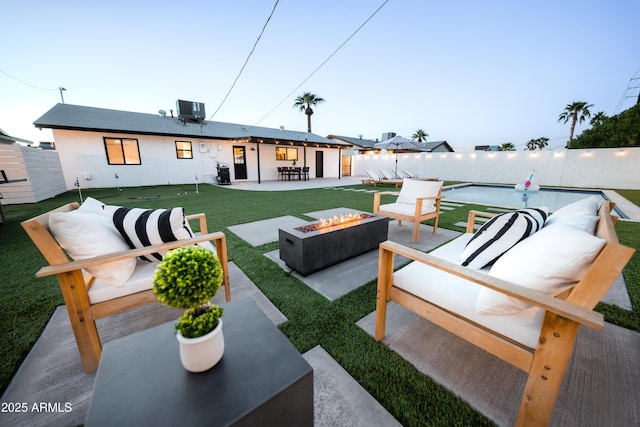 view of patio / terrace with central AC, an outdoor living space with a fire pit, and a grill