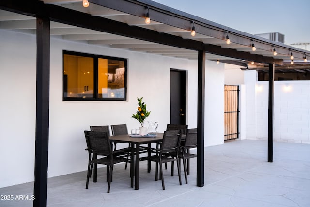 view of patio with outdoor dining space and fence