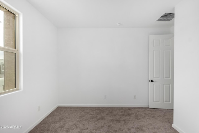 empty room featuring light carpet