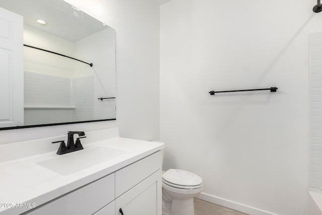 bathroom featuring tile patterned flooring, vanity, and toilet