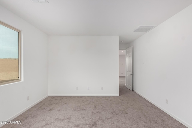 unfurnished room featuring light colored carpet