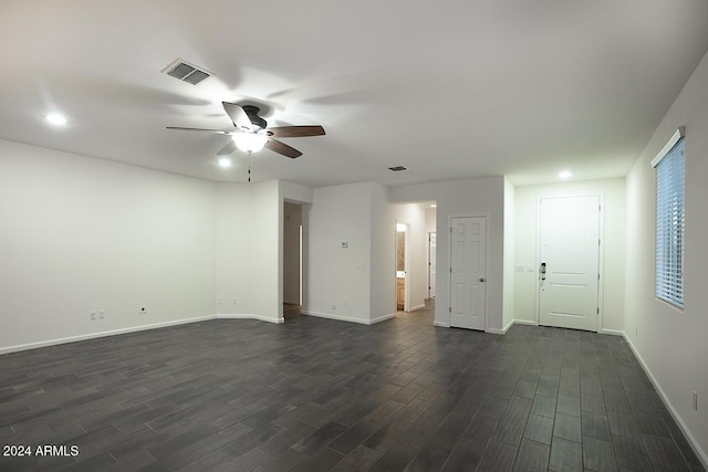 spare room featuring ceiling fan and dark wood-type flooring