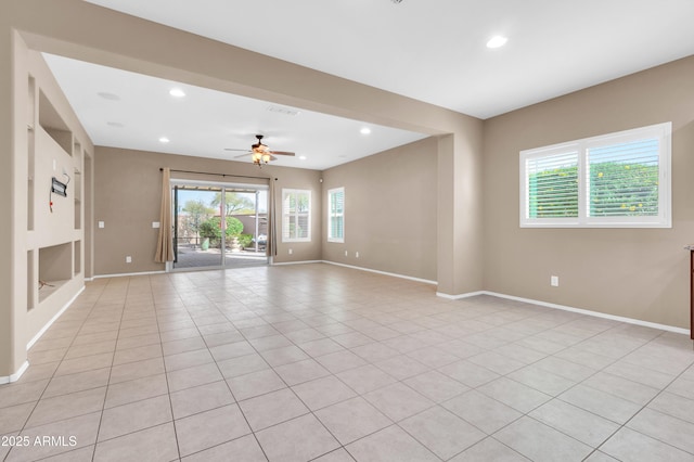 empty room featuring baseboards, a wealth of natural light, and recessed lighting