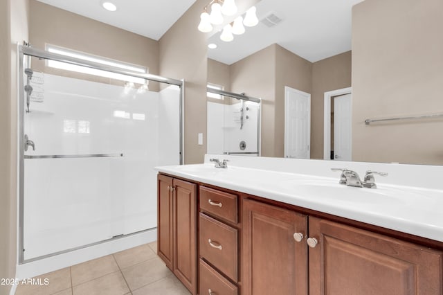 bathroom with a sink, visible vents, tile patterned floors, double vanity, and a stall shower