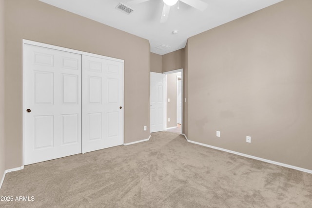 unfurnished bedroom with ceiling fan, carpet flooring, visible vents, baseboards, and a closet