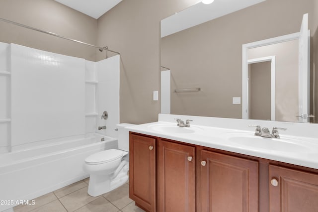 bathroom with double vanity, tile patterned flooring, a sink, and washtub / shower combination