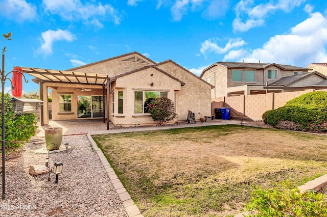 rear view of property with a yard, a patio, stucco siding, fence, and a pergola