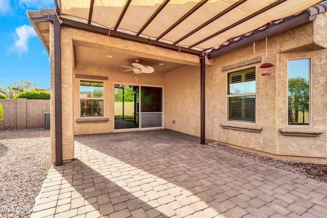 view of patio / terrace featuring fence and a ceiling fan