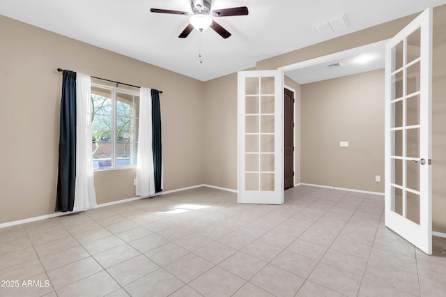 empty room featuring baseboards, visible vents, a ceiling fan, french doors, and light tile patterned flooring