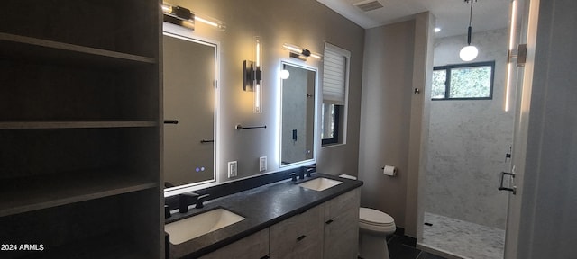 bathroom featuring tile patterned flooring, vanity, toilet, and a shower with shower door