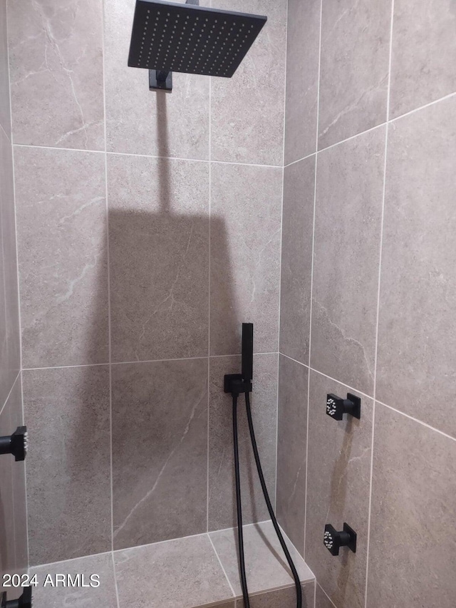 bathroom with a tile shower