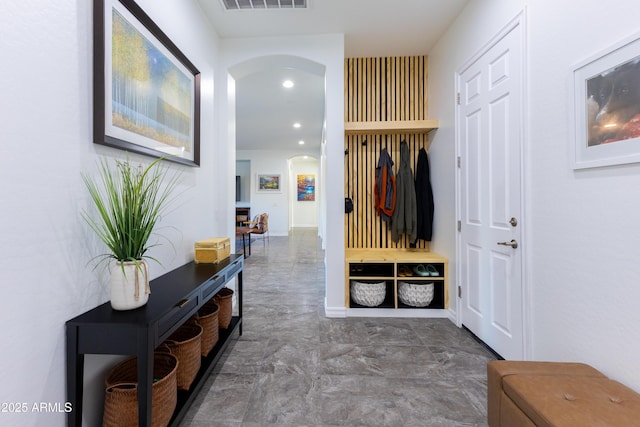 mudroom with arched walkways, visible vents, and recessed lighting