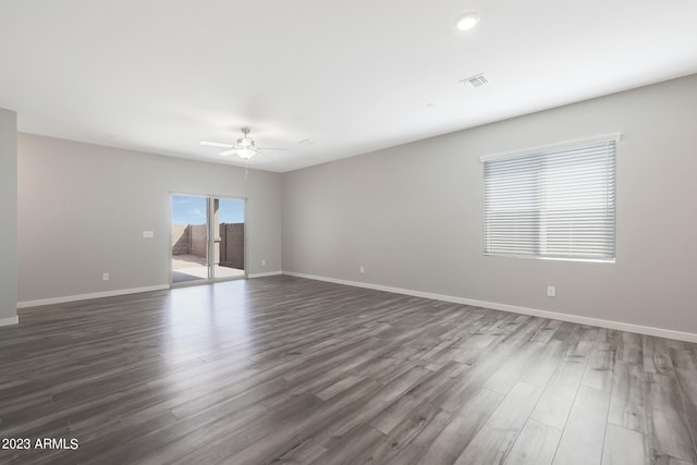 empty room featuring dark hardwood / wood-style flooring and ceiling fan