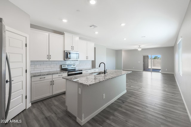 kitchen with sink, dark wood-type flooring, a kitchen island with sink, white cabinets, and appliances with stainless steel finishes