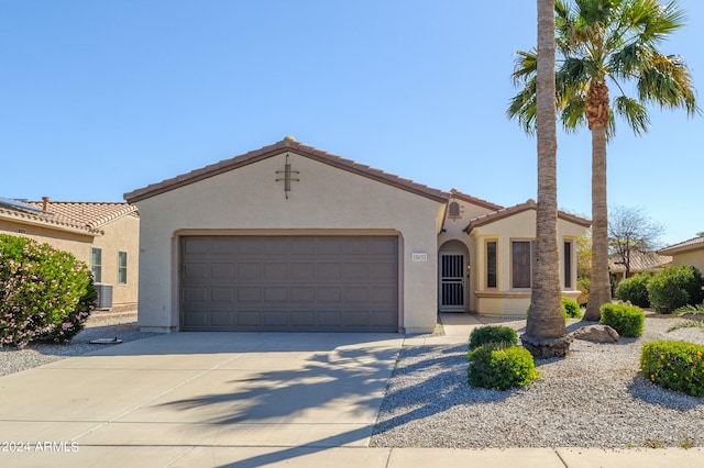 mediterranean / spanish home with central AC and a garage