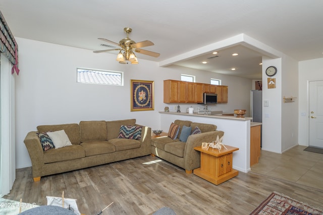 living room with ceiling fan and light hardwood / wood-style floors