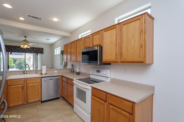 kitchen featuring stainless steel appliances, light tile flooring, ceiling fan, and sink