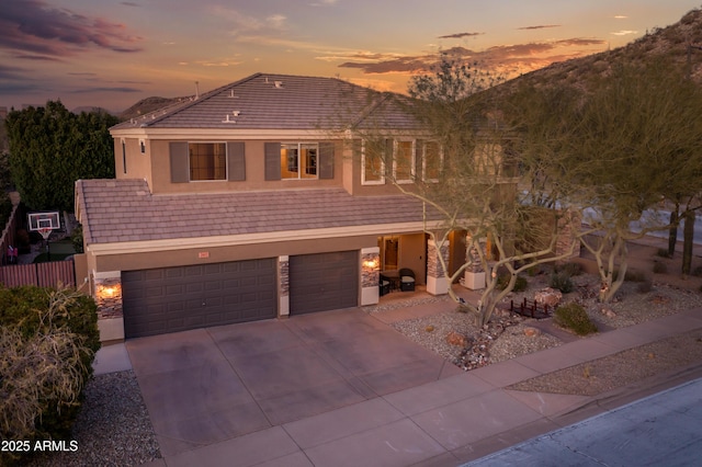 view of front facade with a mountain view and a garage