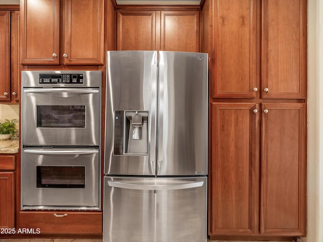 kitchen with appliances with stainless steel finishes and light stone countertops