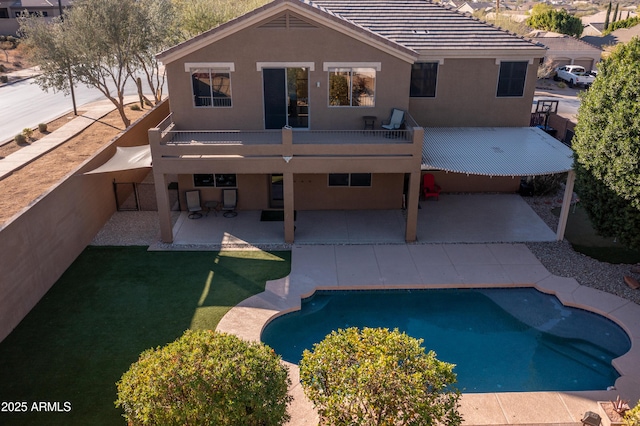 back of property featuring a deck and a patio area