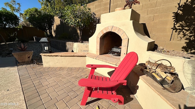 view of patio featuring an outdoor fireplace