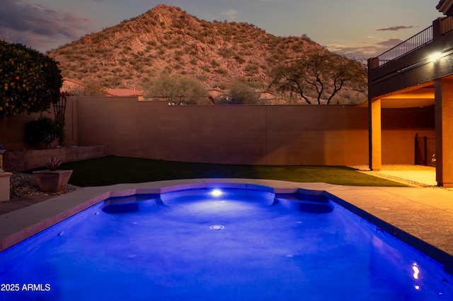 pool at dusk with a mountain view