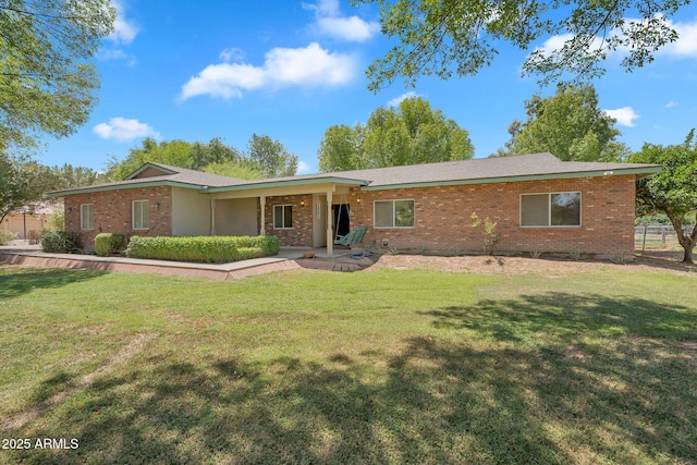 3887 E Via Del Rancho Rd, Gilbert, AZ 85298 - ranch-style home featuring brick siding, a front lawn, and a patio
