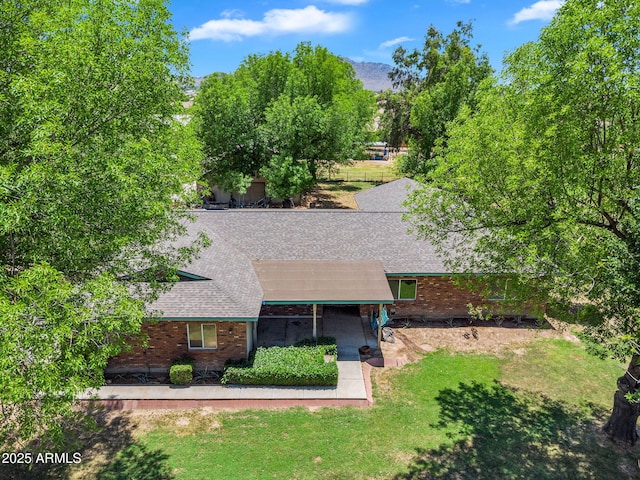 3887 E Via Del Rancho Rd, Gilbert, AZ 85298 - view of front of house with brick siding, roof with shingles, and a front lawn