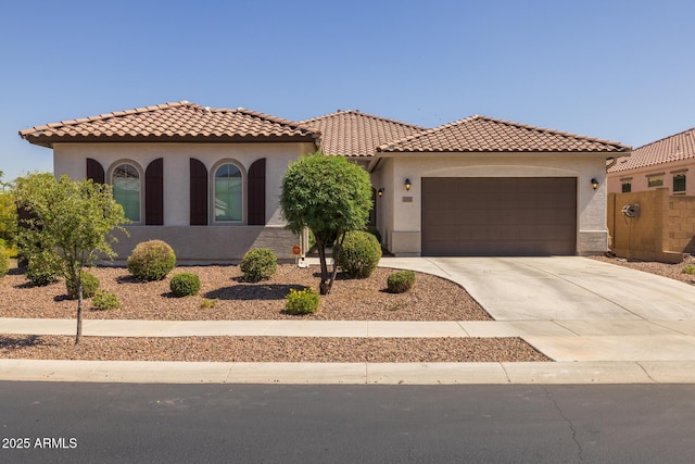 2750 W Pollack St, Phoenix, AZ 85041 - mediterranean / spanish house with a garage, concrete driveway, stucco siding, and a tiled roof
