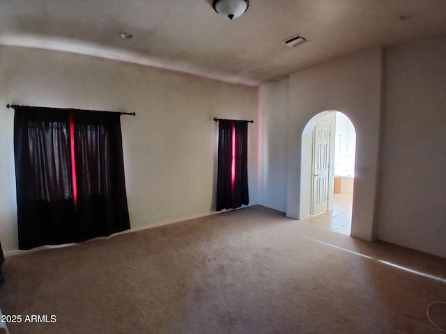 unfurnished room with light colored carpet