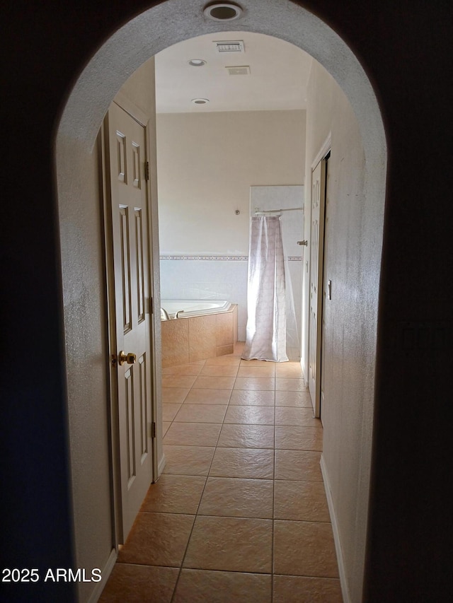 hall with light tile patterned flooring