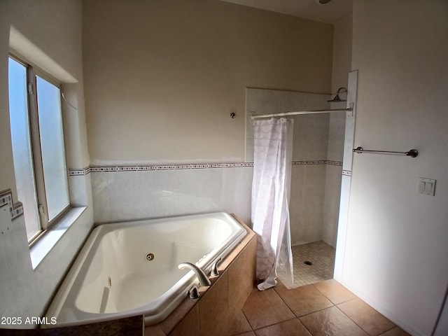 bathroom with independent shower and bath and tile patterned flooring