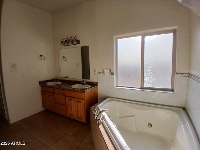 bathroom featuring vanity, tile patterned flooring, and tiled tub