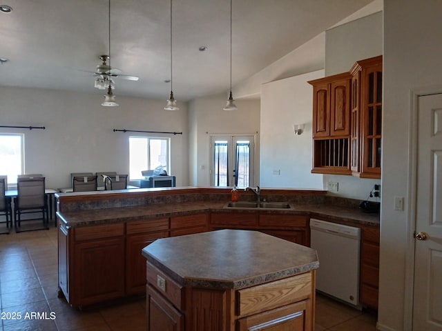 kitchen with sink, decorative light fixtures, dishwasher, and a kitchen island