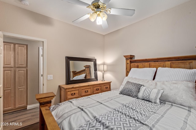 bedroom featuring ceiling fan and dark hardwood / wood-style flooring