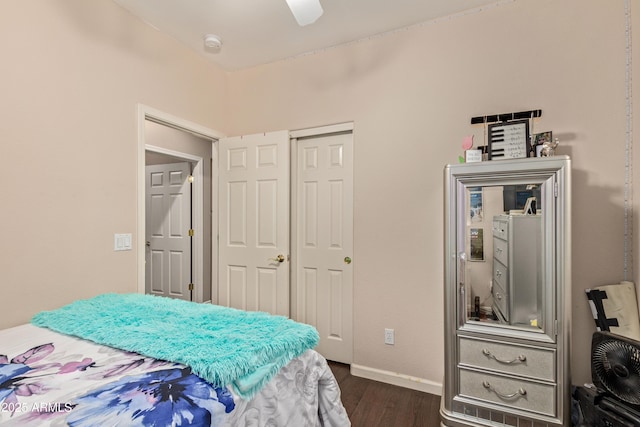 bedroom featuring ceiling fan, a closet, and dark wood-type flooring