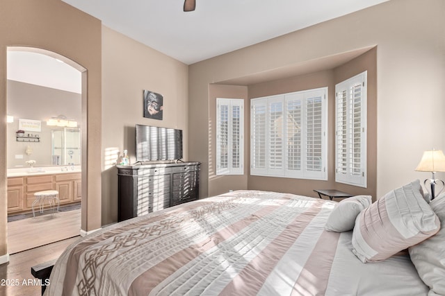 bedroom featuring ceiling fan and connected bathroom