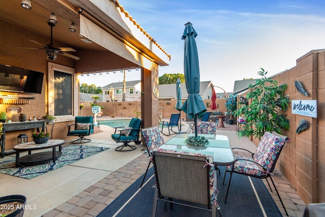 view of patio / terrace featuring a fenced in pool and ceiling fan