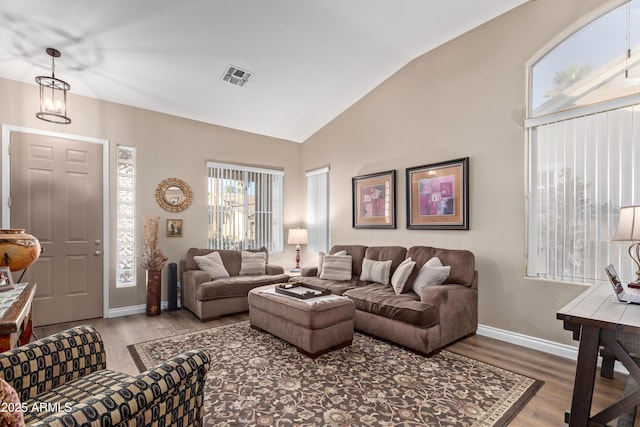 living room with hardwood / wood-style flooring and vaulted ceiling