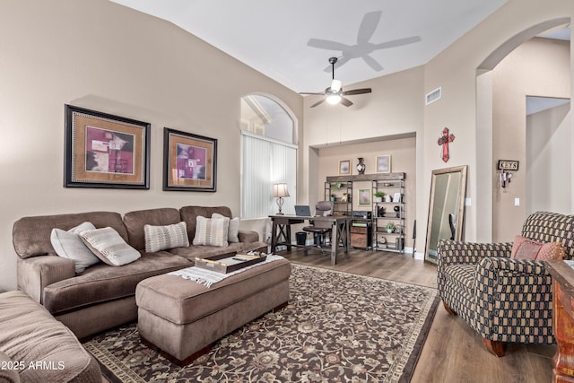 living room featuring wood-type flooring, vaulted ceiling, and ceiling fan